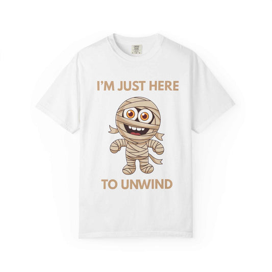 White t-shirt with a cartoon mummy and the text "I'm Just Here to Unwind".