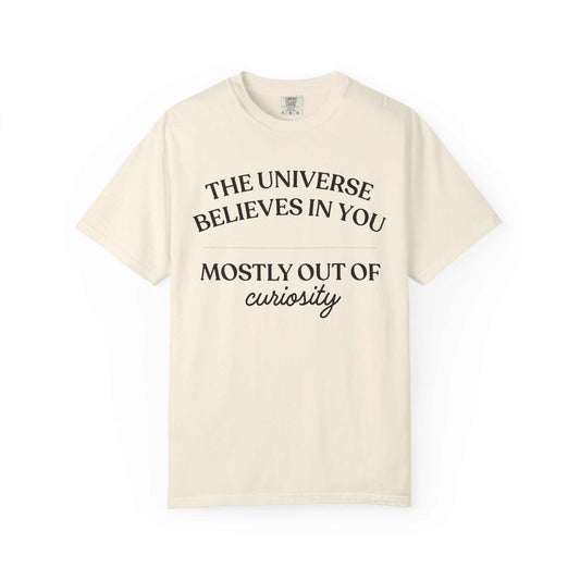 Comfort Colors cream graphic tee with 'The universe believes in you mostly out of curiosity' text