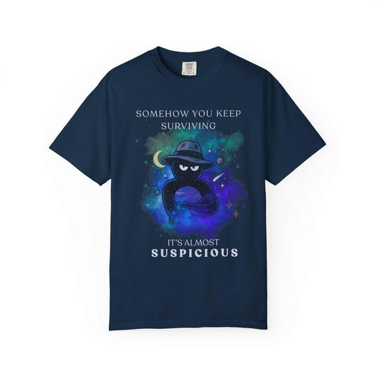 Navy t-shirt with galaxy background, mysterious figure, and text 'Somehow you keep surviving, it's almost suspicious' from Youniverses.
