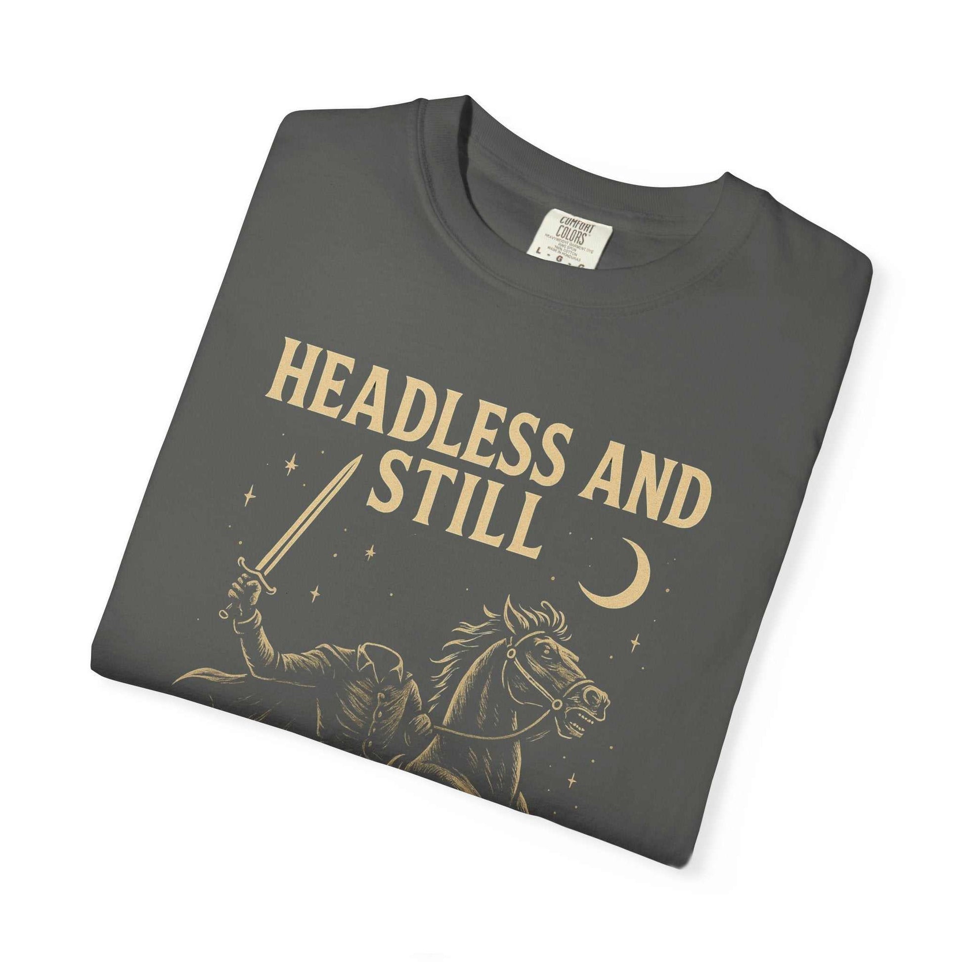 Folded eco-friendly Headless Horseman shirt with spooky motivational design and text "Headless and Still" on gray cotton tee