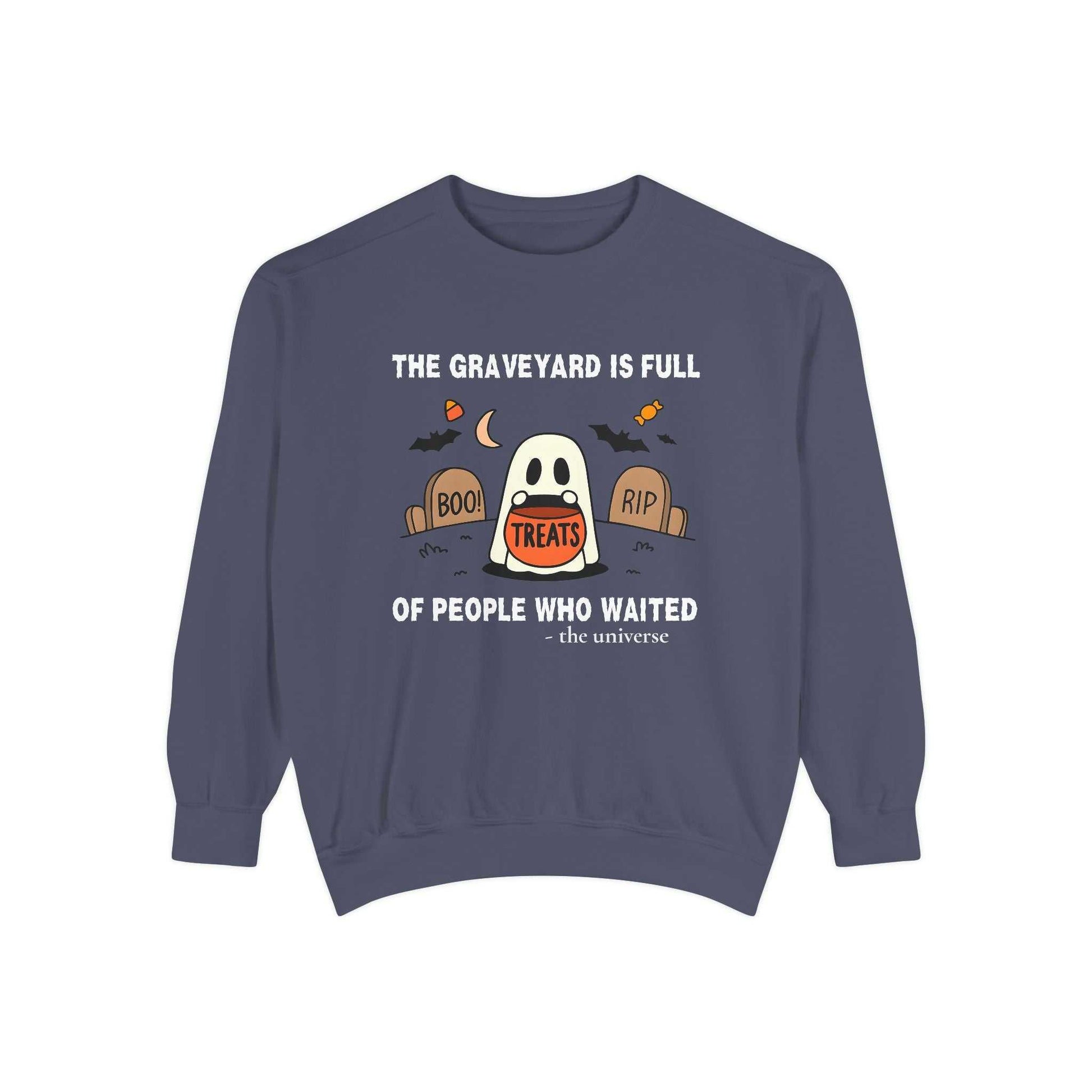 Sweatshirt with a ghost holding a treat bucket in a graveyard.