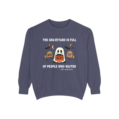 Sweatshirt with a ghost holding a treat bucket in a graveyard.