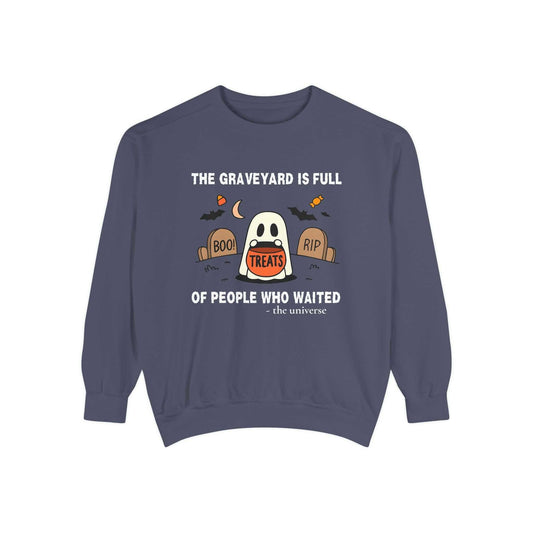 Sweatshirt with a ghost holding a treat bucket in a graveyard.