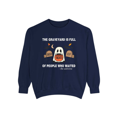 Sweatshirt with a Halloween design of a ghost in a graveyard holding treats.