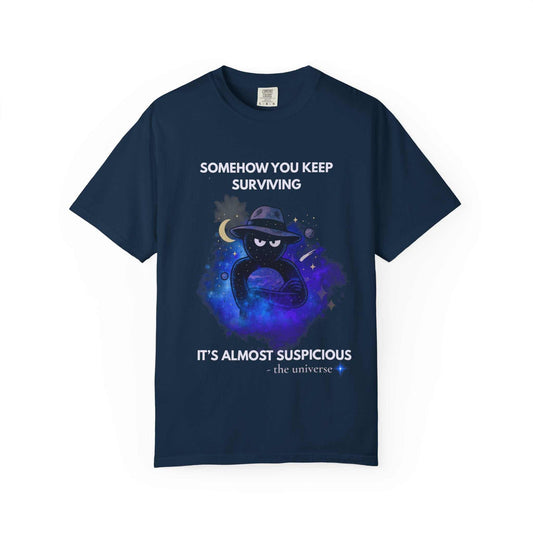 A navy t-shirt with a cosmic graphic and the text "Somehow You Keep Surviving".