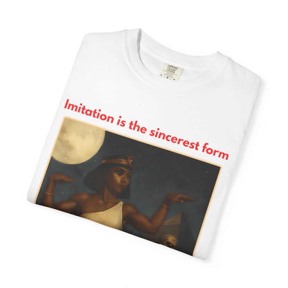 Folded white unisex cotton t-shirt with Egyptian mummy design and "Imitation is the sincerest form" text.