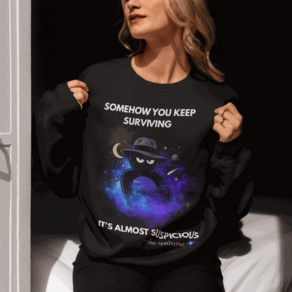 Black sweatshirt with "Somehow You Keep Surviving" text and a cosmic graphic.