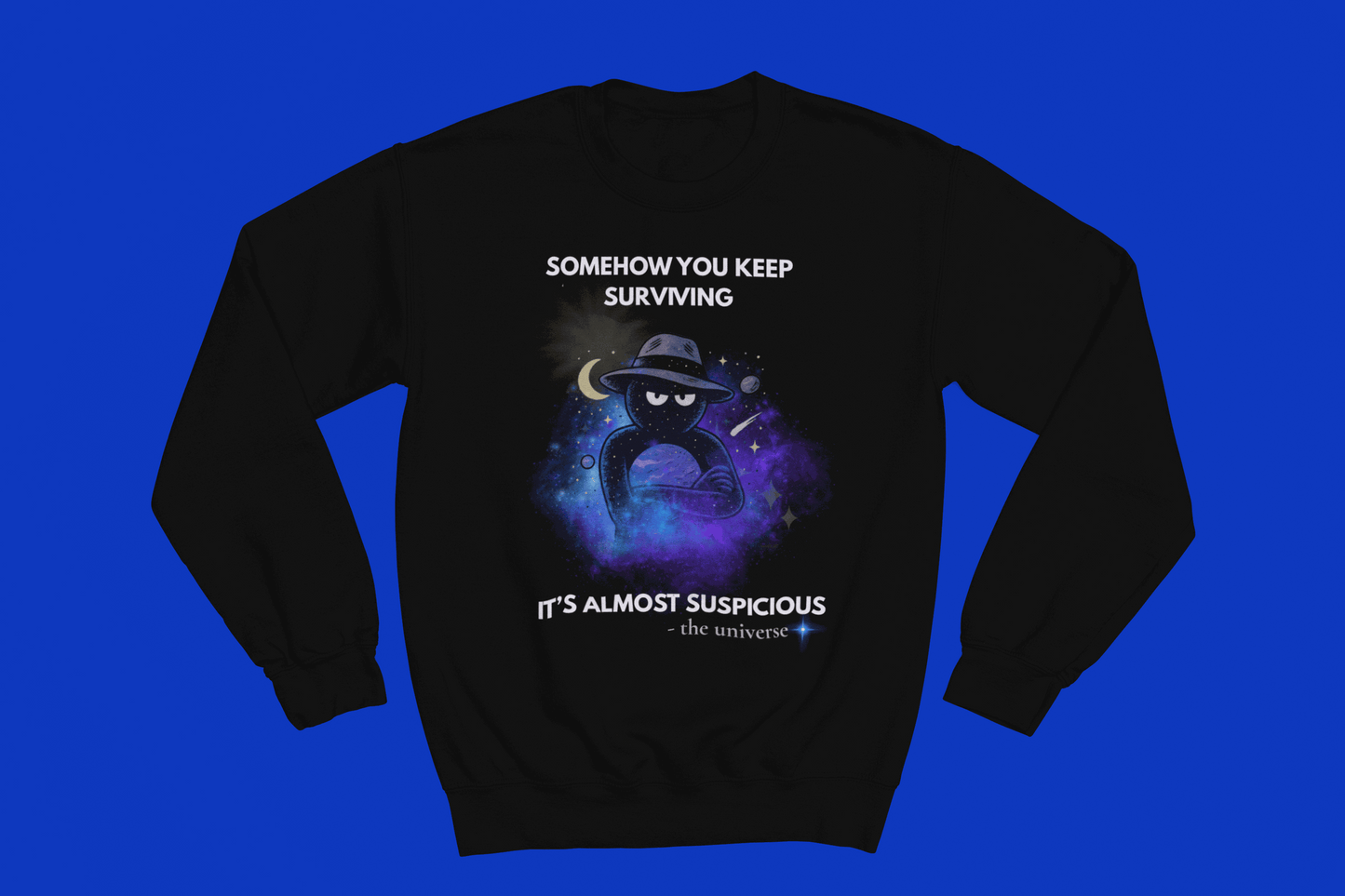 Black sweatshirt with a cosmic graphic and text "Somehow you keep surviving it's almost suspicious".