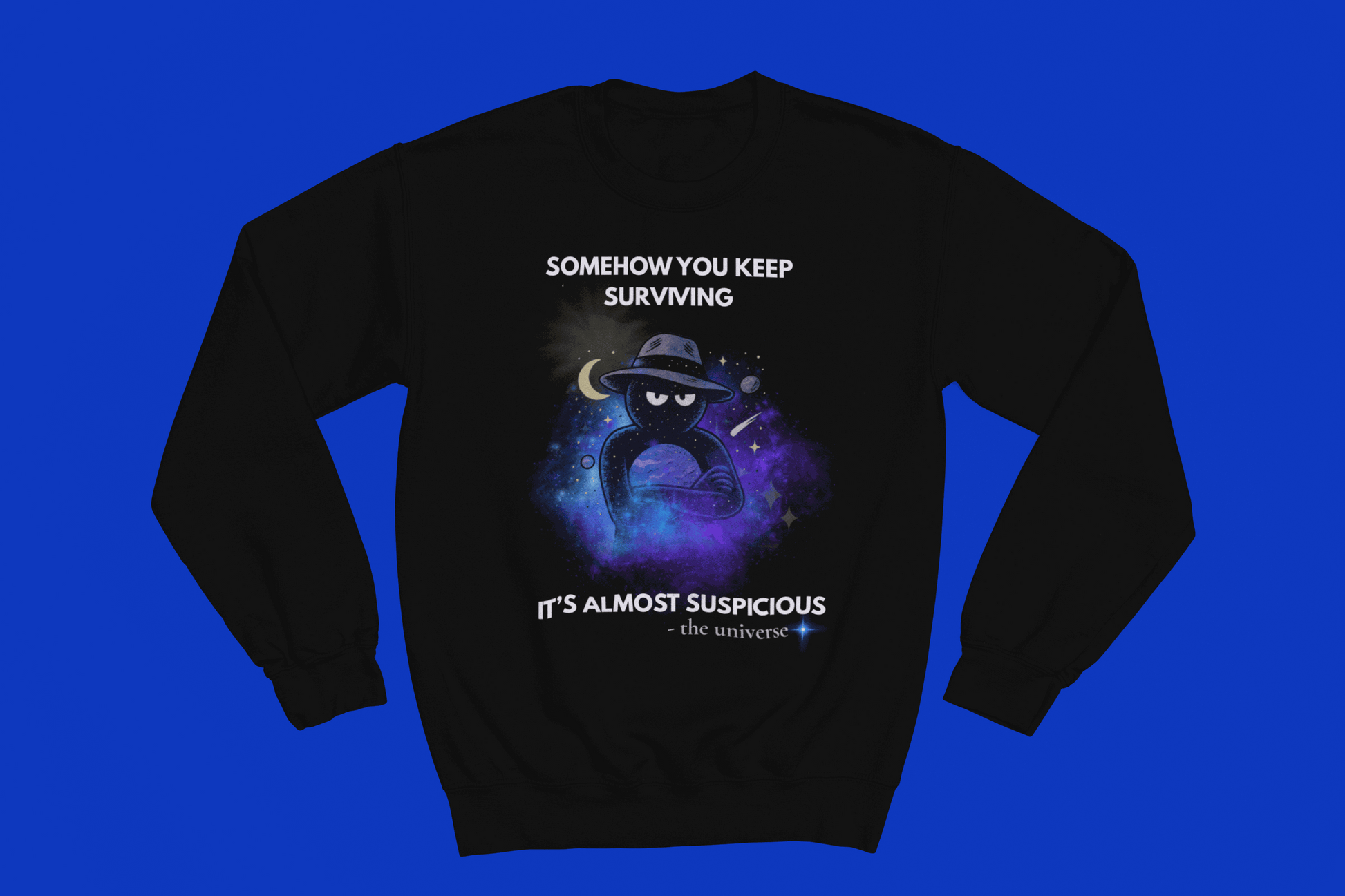 Black sweatshirt with a cosmic graphic and text "Somehow you keep surviving it's almost suspicious".