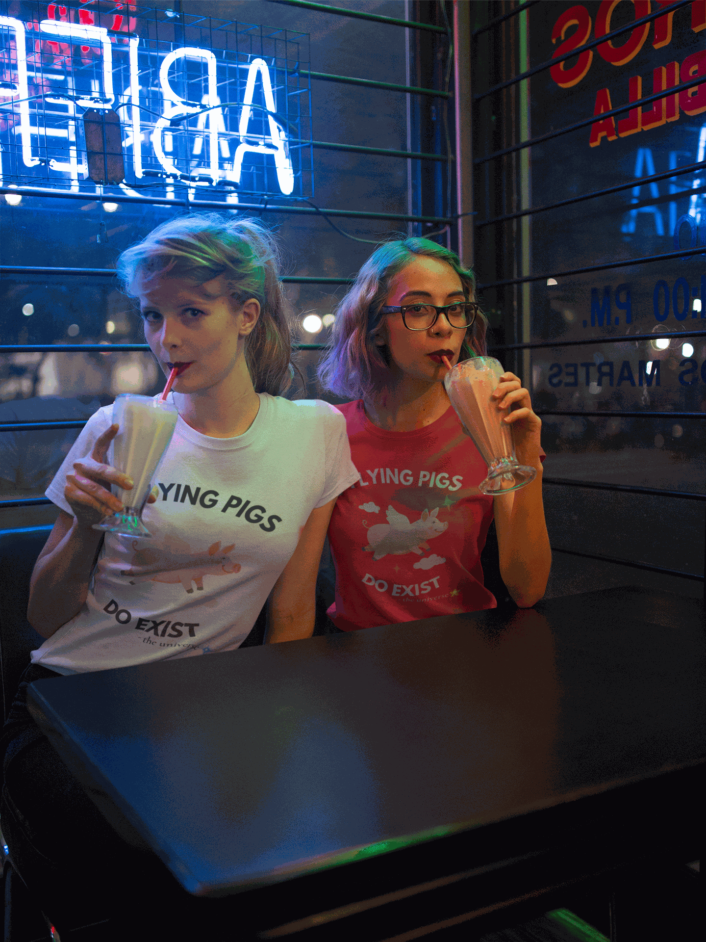 A white t-shirt with a graphic of a flying pig and the text "LYING PIGS DO EXIST".