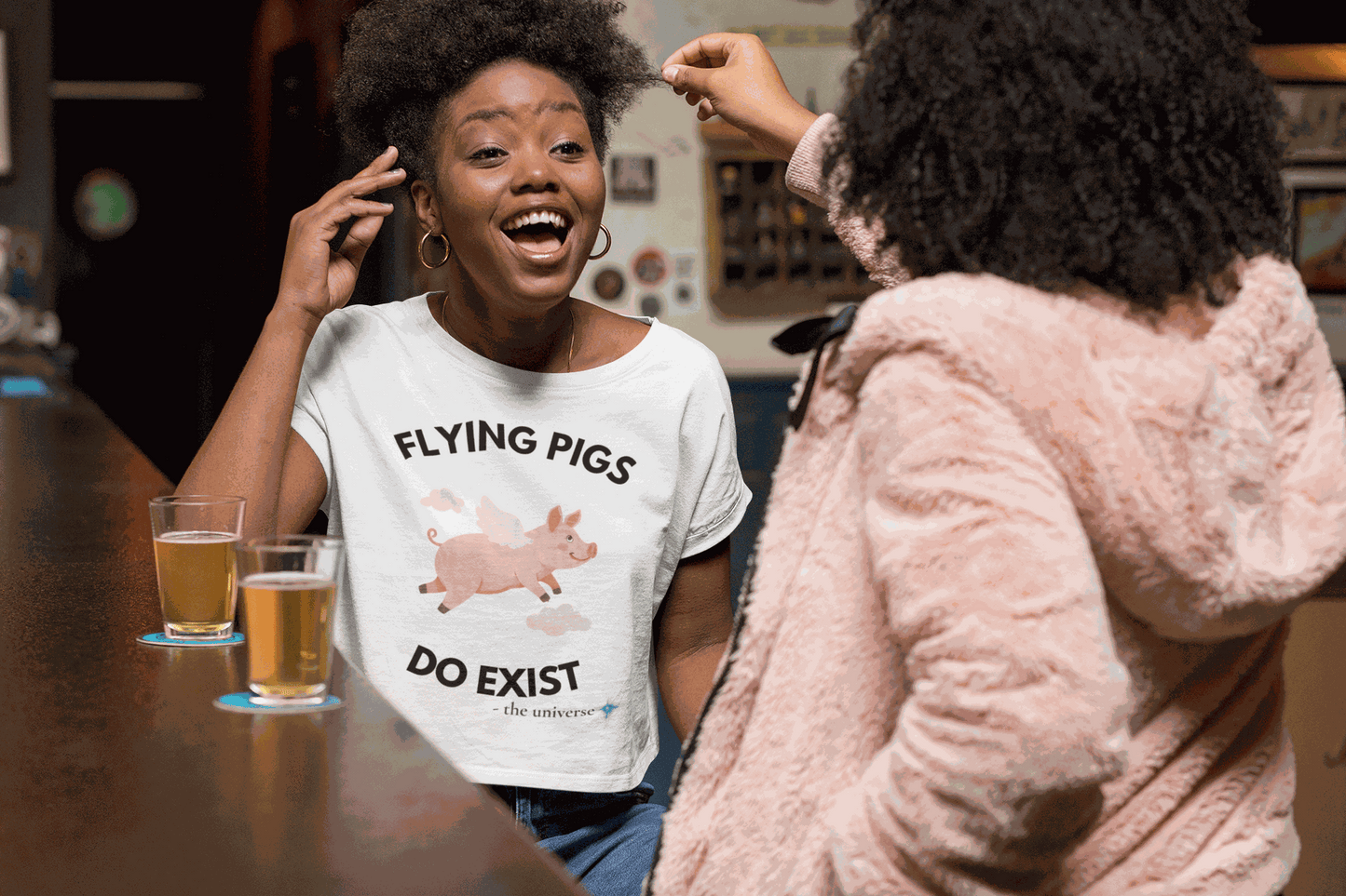 A white t-shirt with a graphic of a flying pig and the text "Flying Pigs Do Exist".