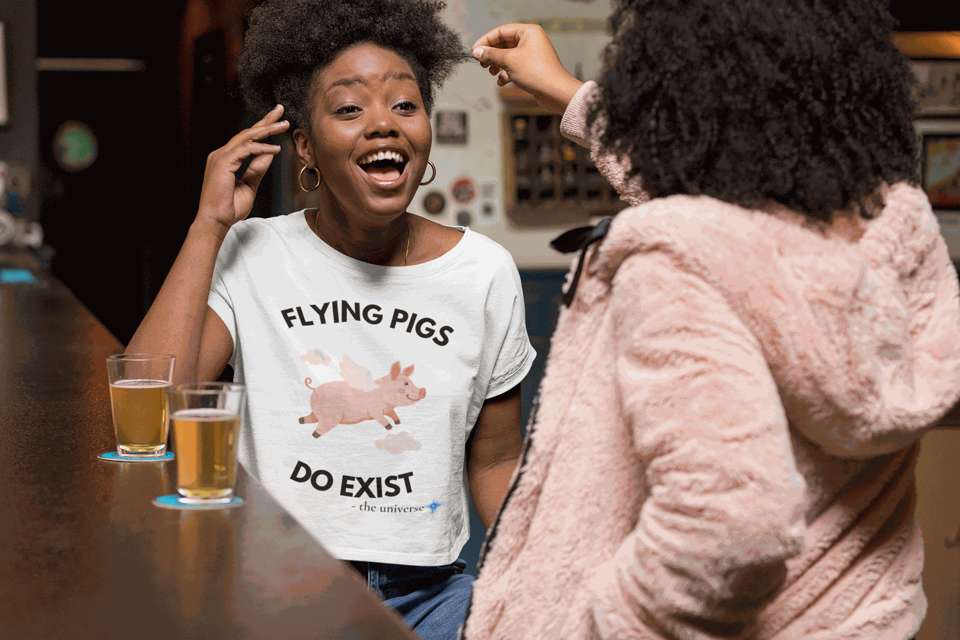 A white t-shirt with a graphic of a flying pig and the text "Flying Pigs Do Exist".