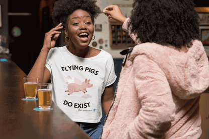 A white t-shirt with a graphic of a flying pig and the text "Flying Pigs Do Exist".