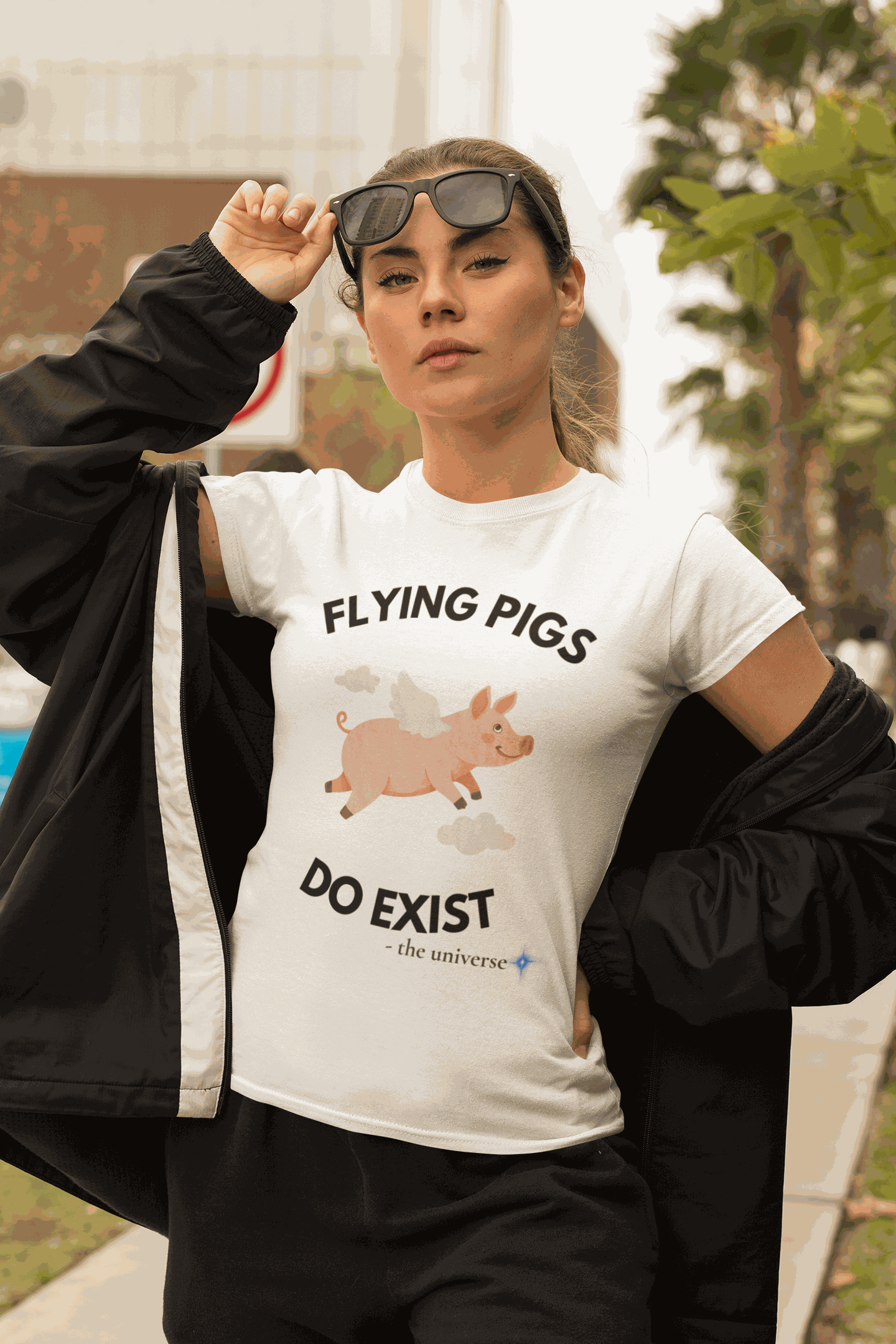 A white t-shirt with a graphic of a flying pig and the text "FLYING PIGS DO EXIST".