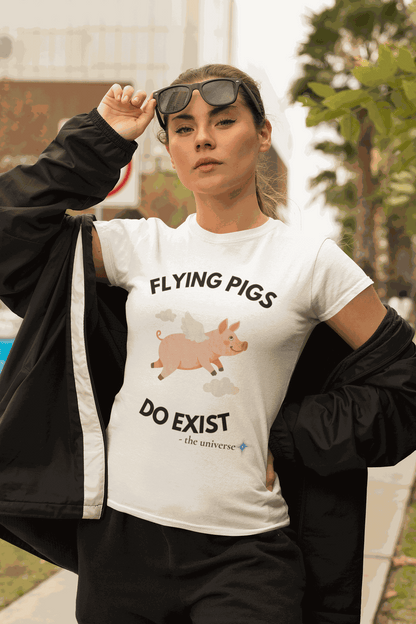 A white t-shirt with a graphic of a flying pig and the text "FLYING PIGS DO EXIST".