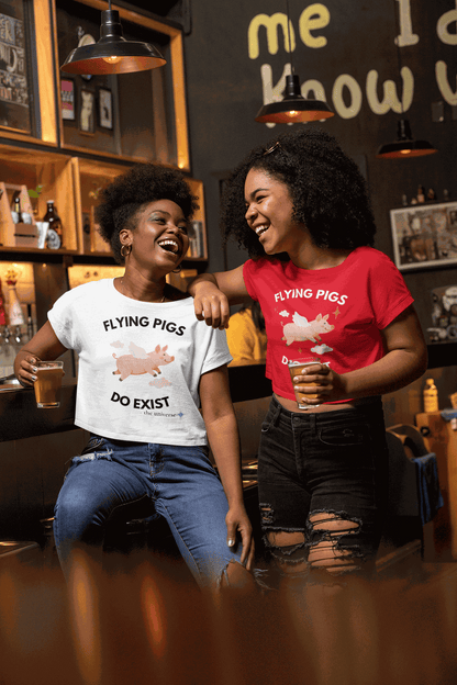 A white crop top with a graphic of a flying pig and the text "Flying Pigs Do Exist".