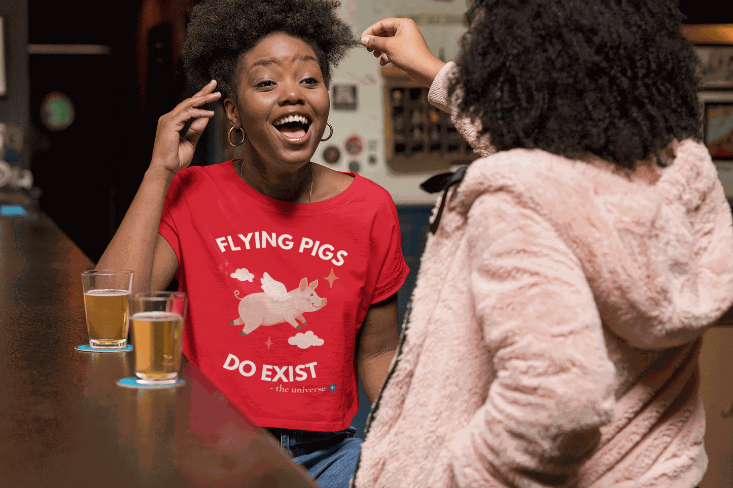 A red t-shirt with a flying pig graphic and the text "Flying Pigs Do Exist".