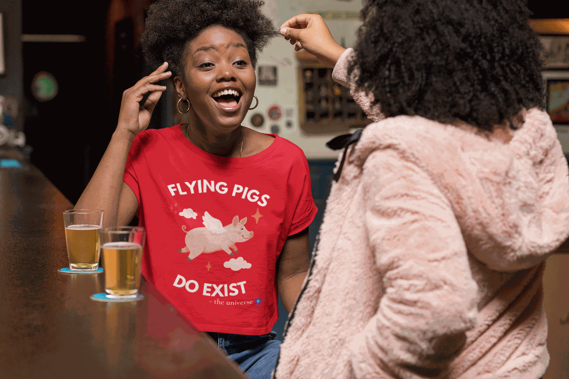 A red t-shirt with a flying pig graphic and the text "Flying Pigs Do Exist".