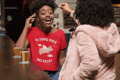 A red t-shirt with a flying pig graphic and the text "Flying Pigs Do Exist".