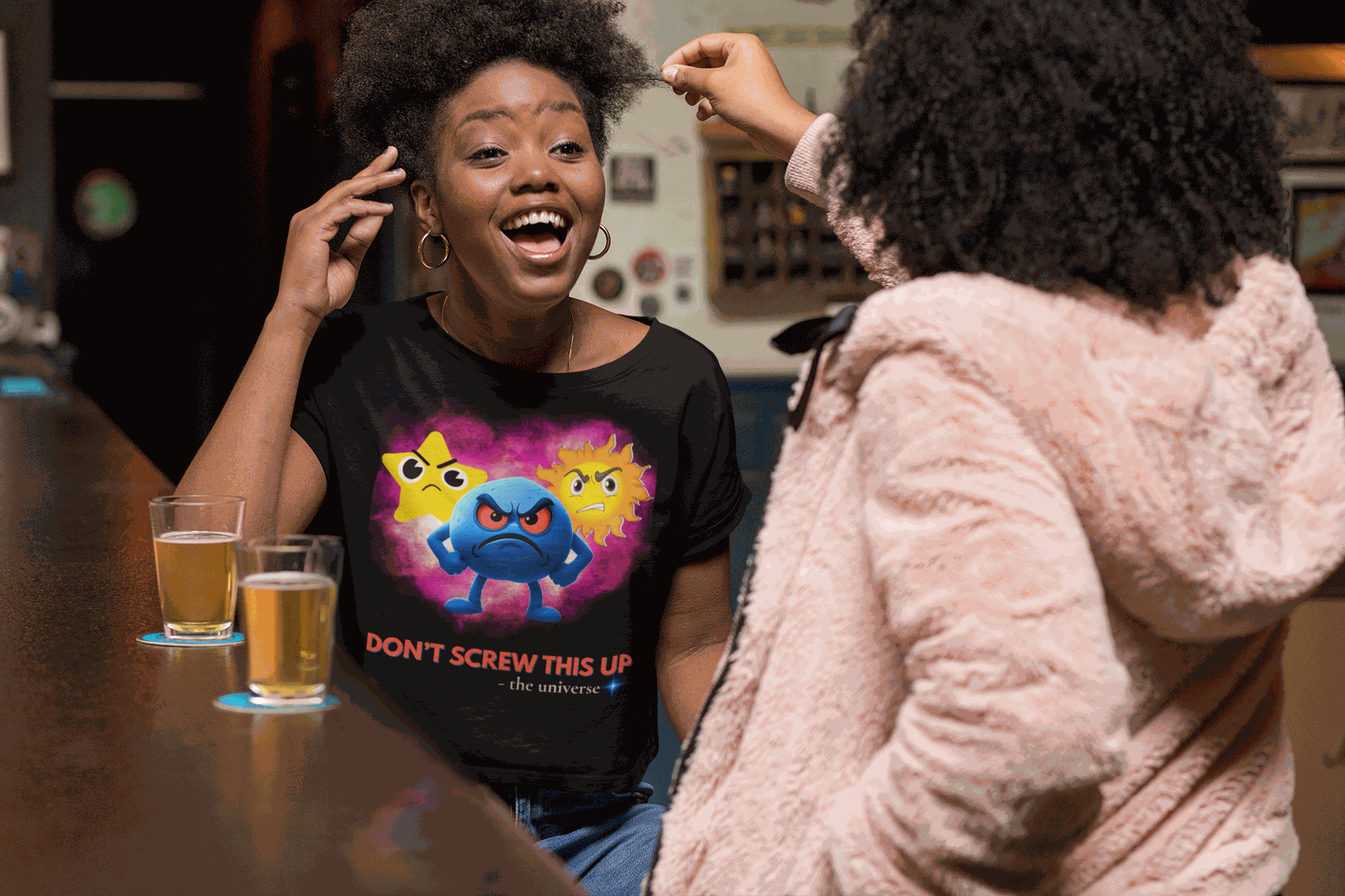 A black t-shirt with a graphic of three angry celestial characters and the text "DON'T SCREW THIS UP".