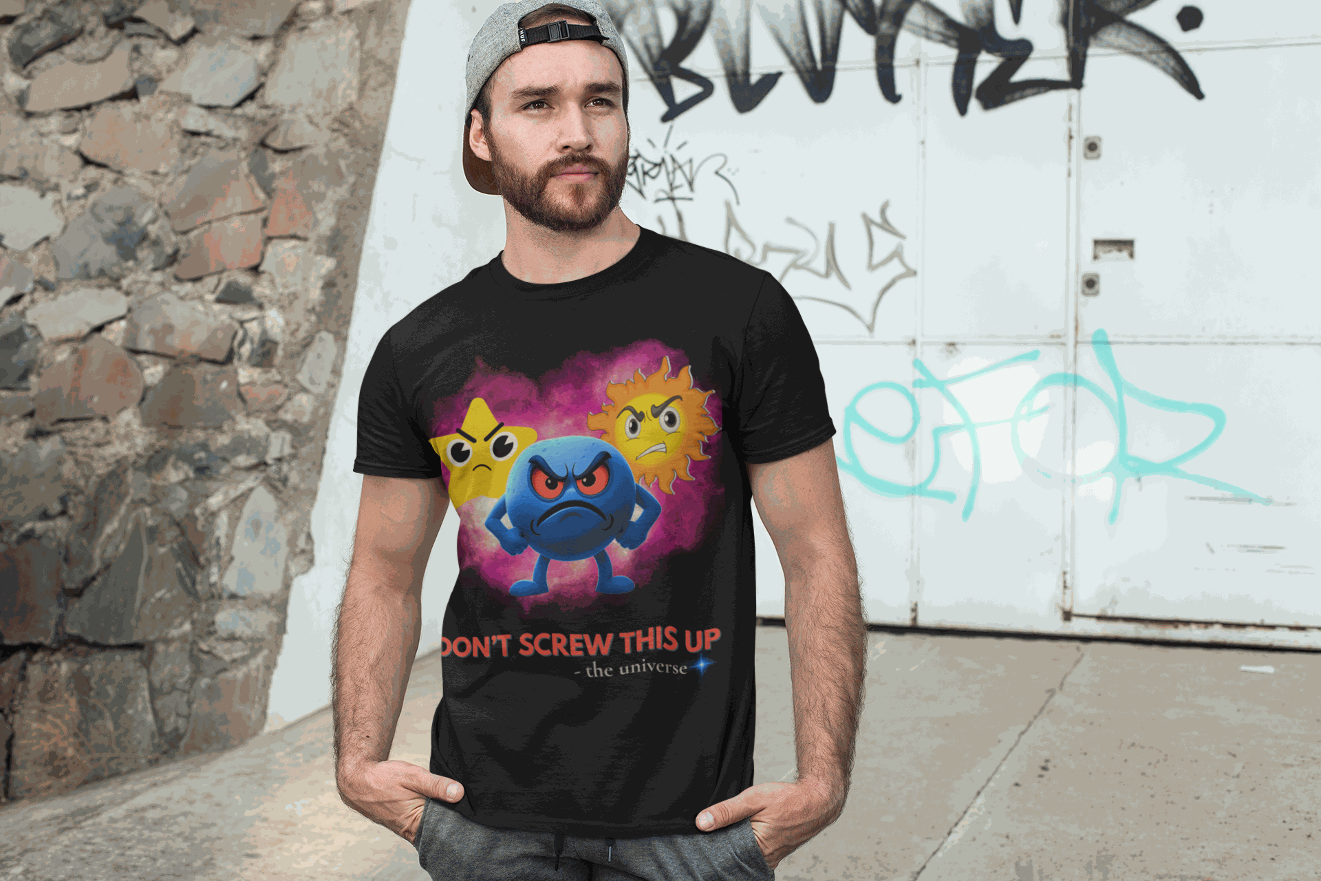 A black t-shirt with a graphic of three angry celestial emojis and the text "Don't Screw This Up - the universe".