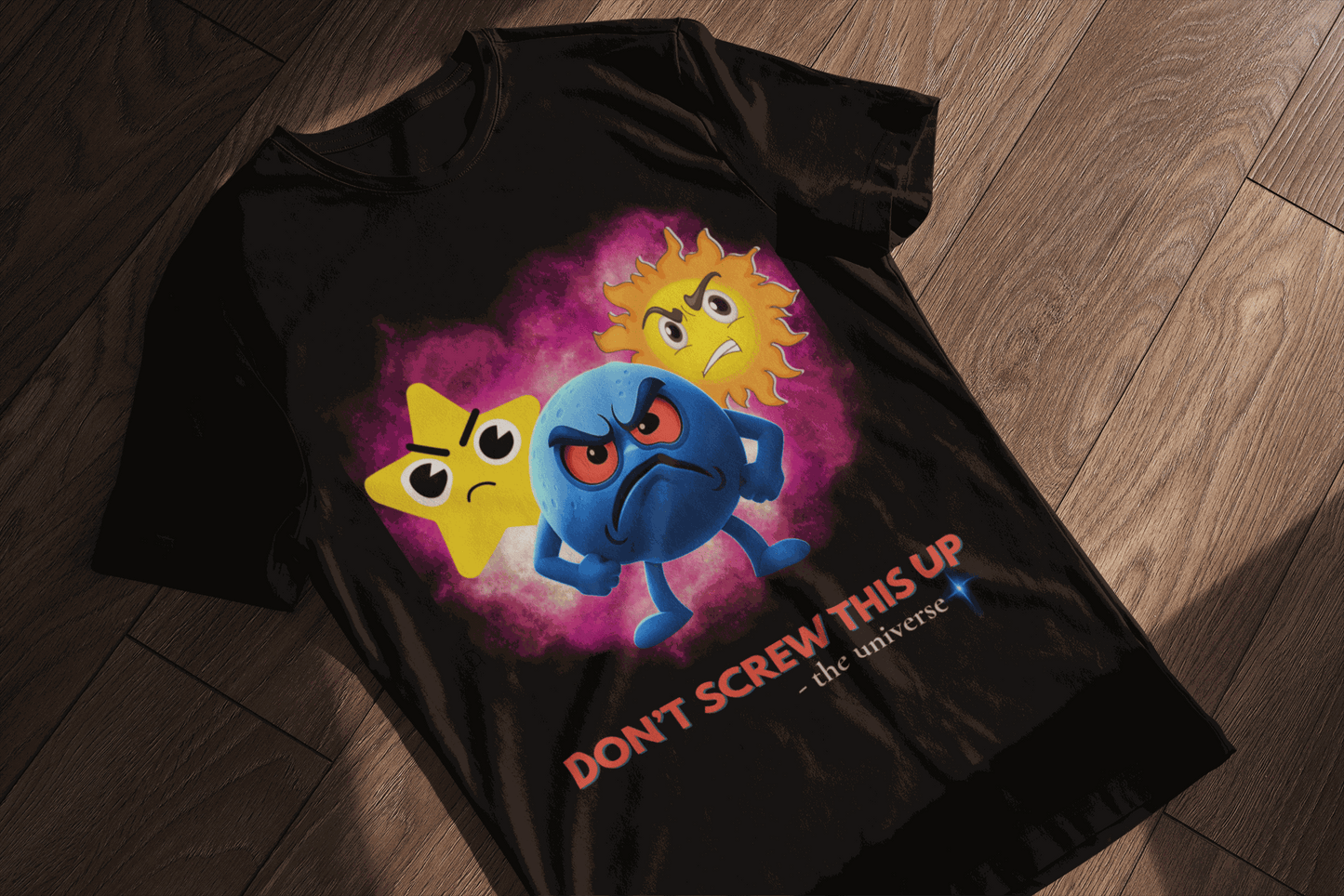 Black t-shirt with angry cartoon stars and planet saying "Don't Screw This Up".