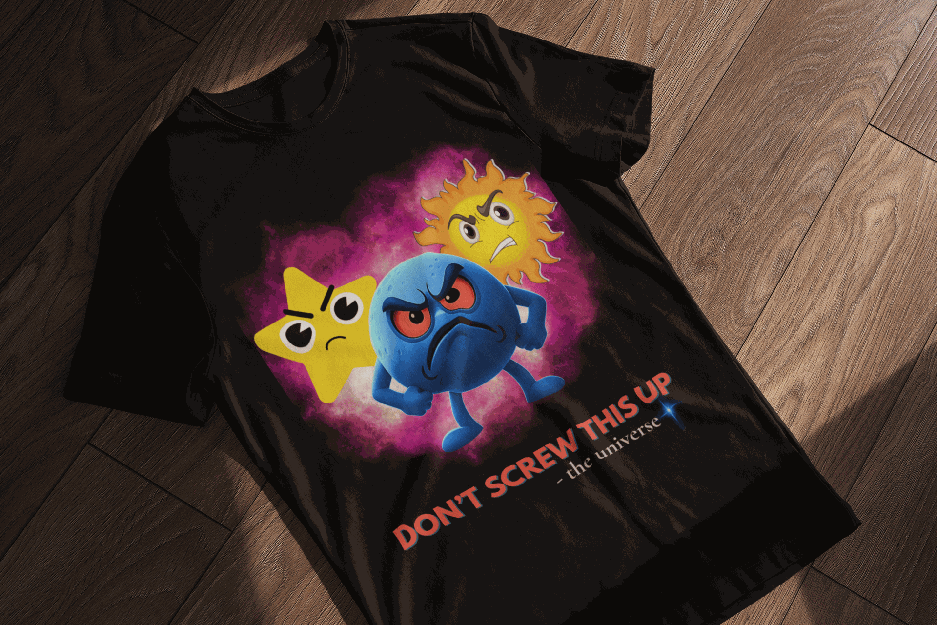 Black t-shirt with angry cartoon stars and planet saying "Don't Screw This Up".