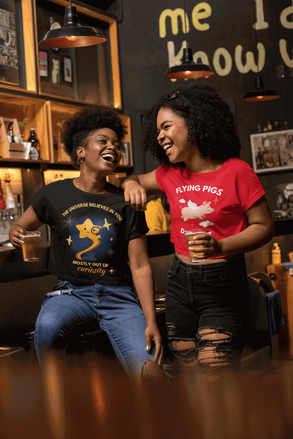 A black t-shirt with a graphic of a curious star and the text "The Universe Believes in You".