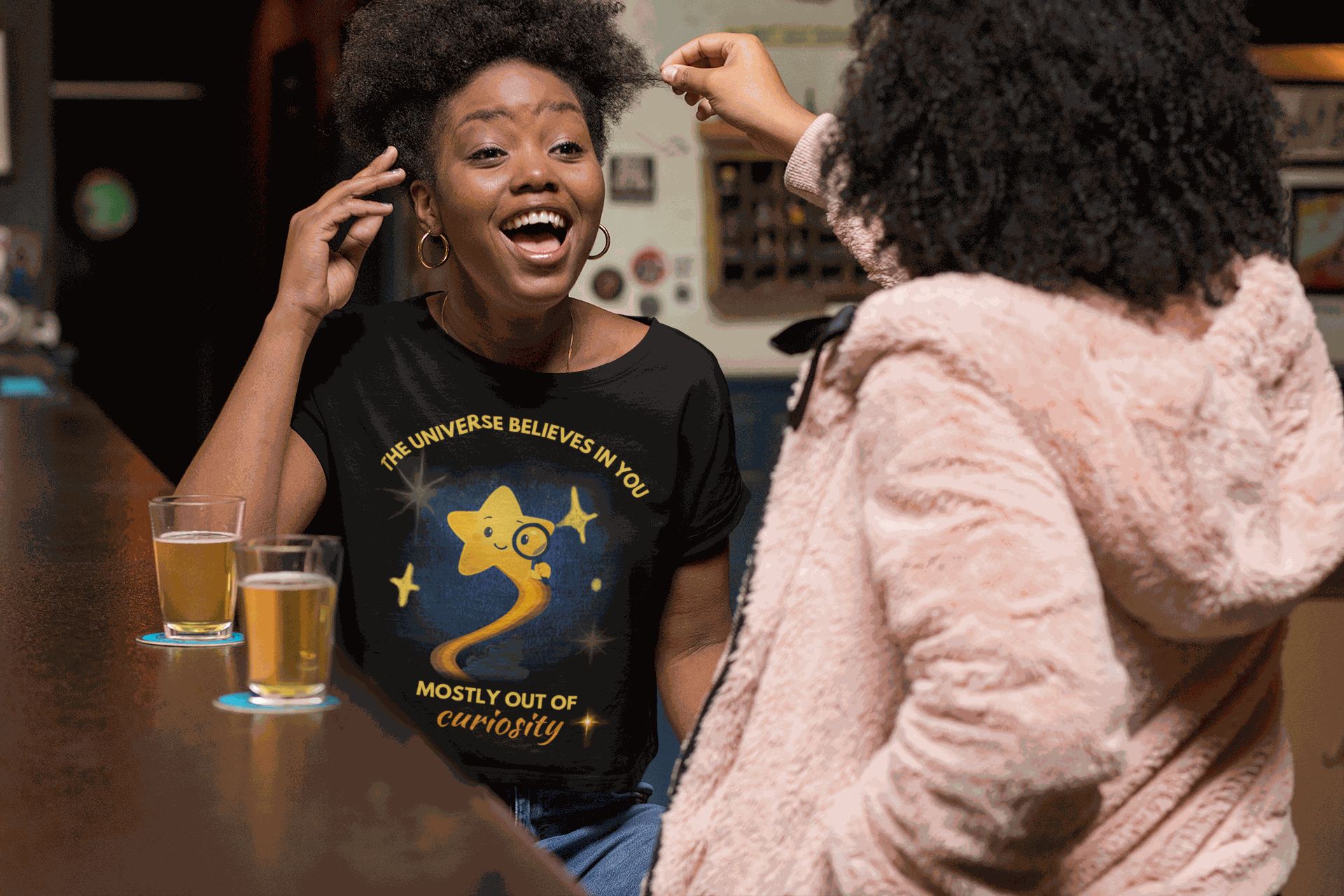 A black t-shirt with a graphic of a curious star and text.