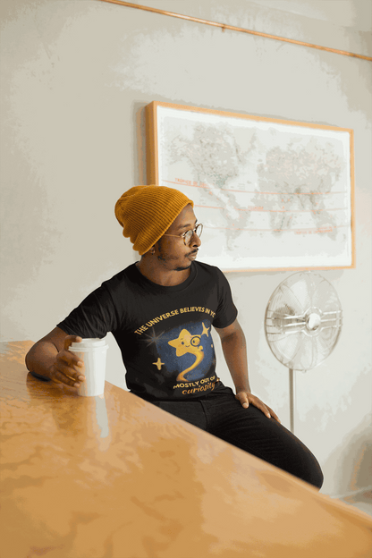 A man wears a black t-shirt with a graphic of a star and text.