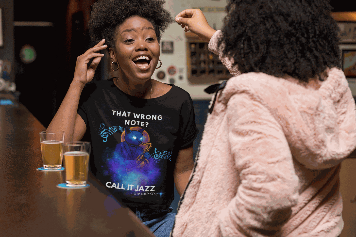 A black t-shirt with a cosmic cat playing a saxophone and the text "That Wrong Note? Call It Jazz".