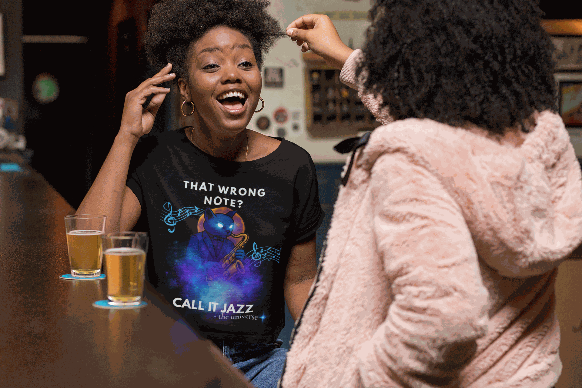A black t-shirt with a cosmic cat playing a saxophone and the text "That Wrong Note? Call It Jazz".