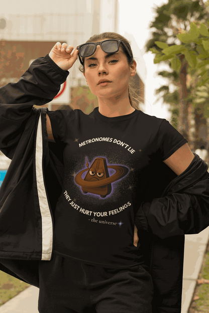 A woman wears a black t-shirt with a graphic of a sad metronome in space.