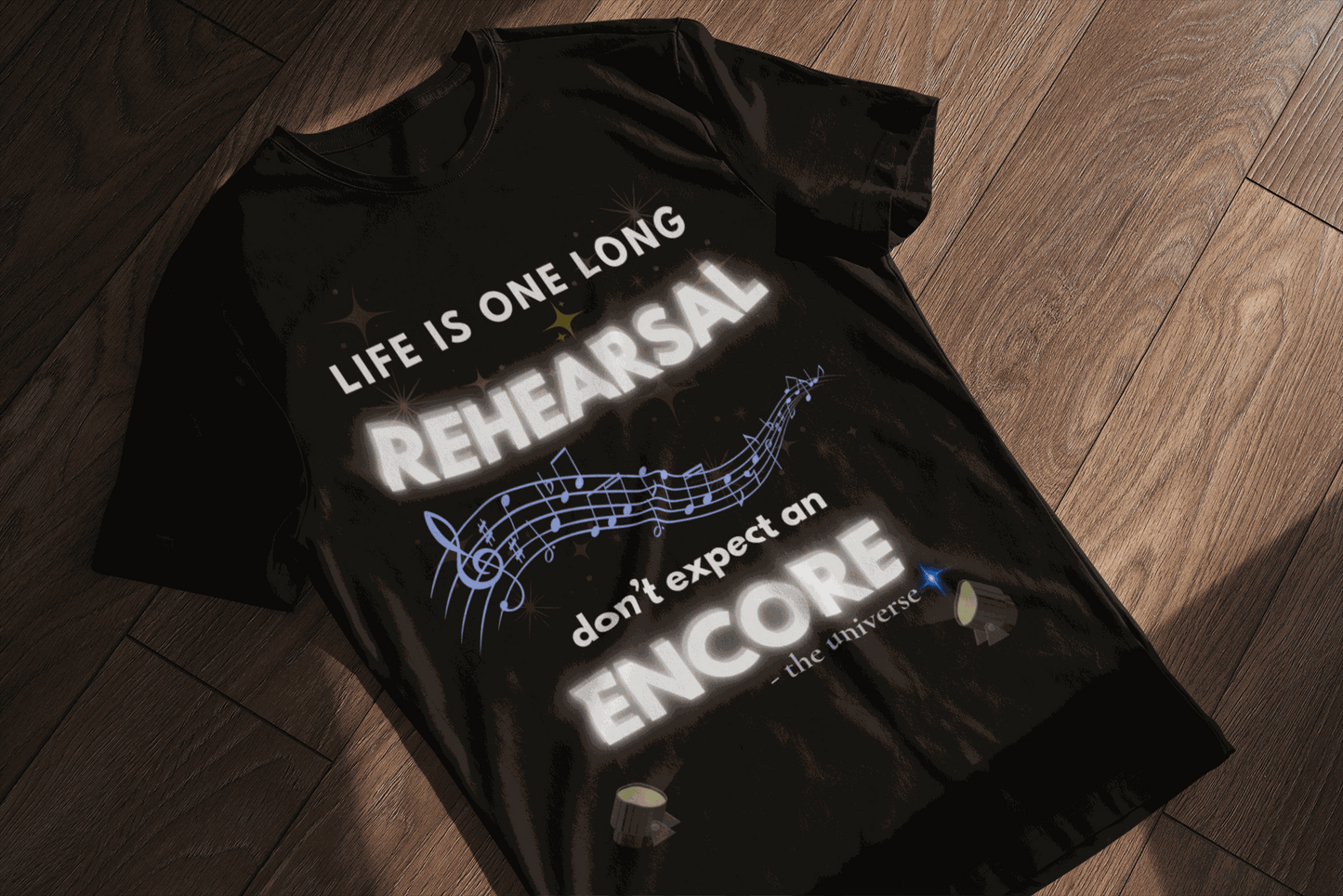 Black t-shirt with "Life Is One Long Rehearsal, Don't Expect an Encore" text and musical notes.