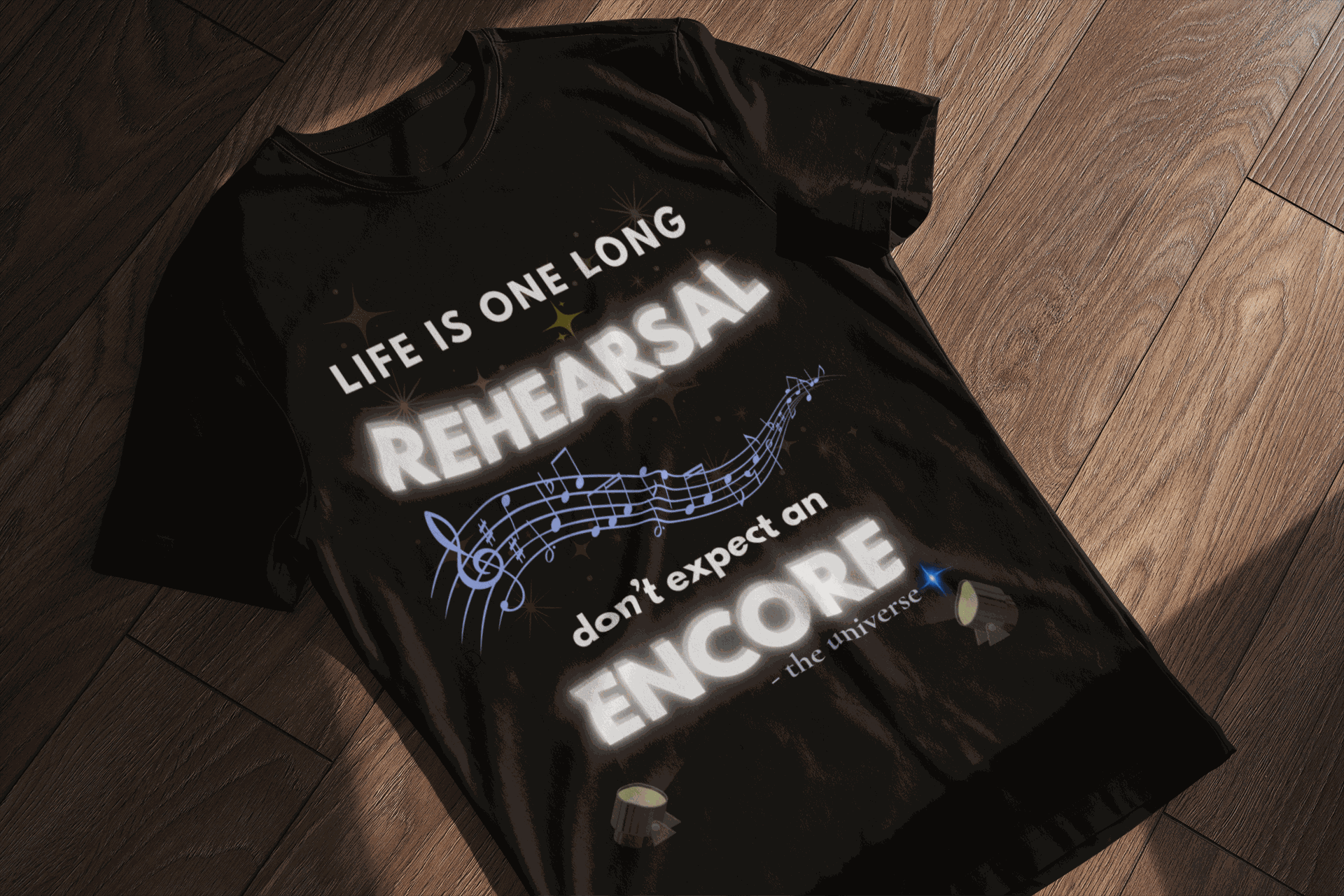 Black t-shirt with "Life Is One Long Rehearsal, Don't Expect an Encore" text and musical notes.