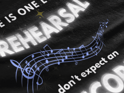 Black t-shirt with white text "Life Is One Long Rehearsal" and musical notes.
