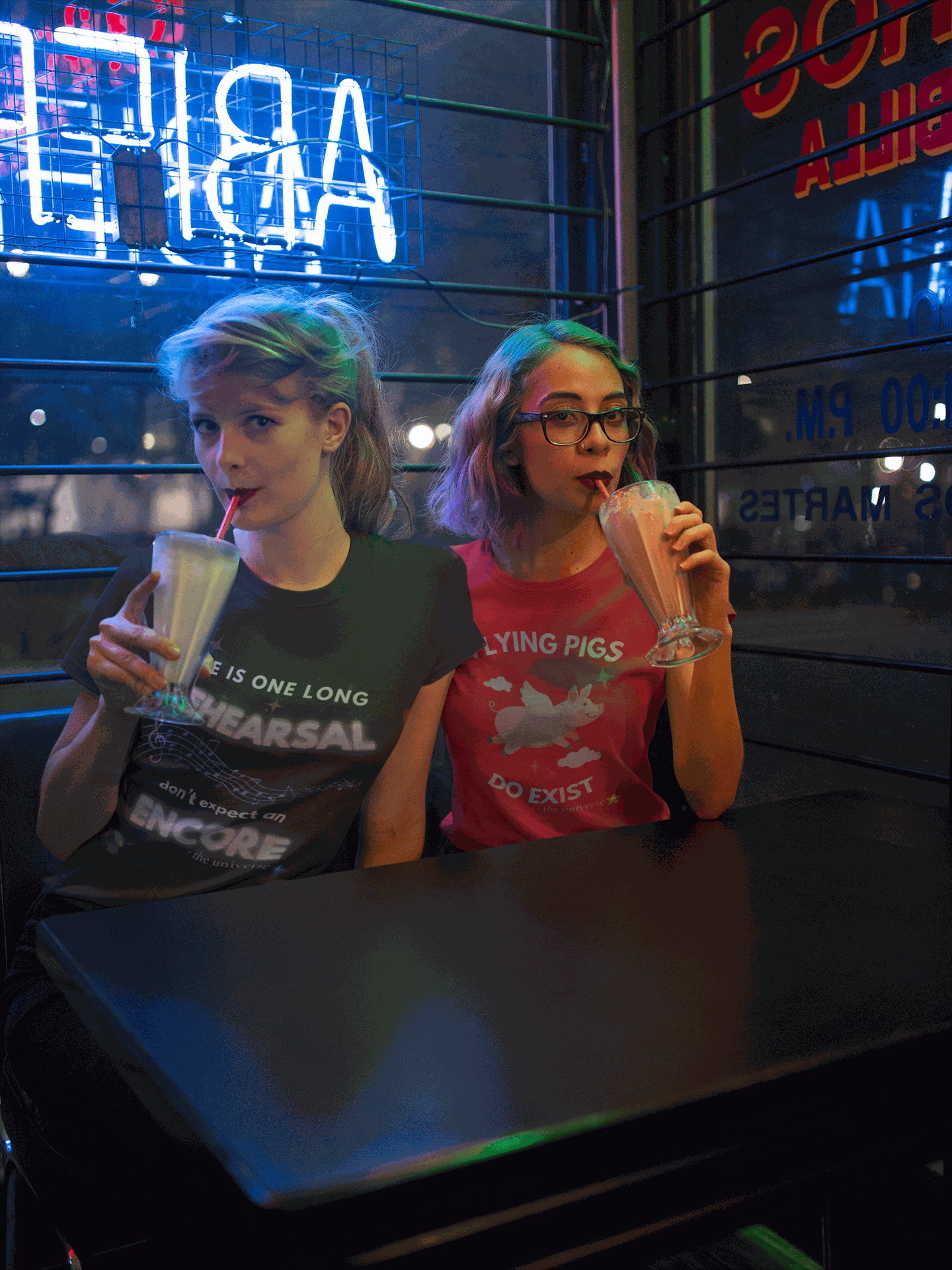 A woman wears a black t-shirt with white text and musical notes.