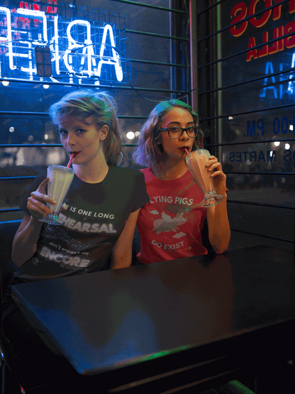 A woman wears a black t-shirt with white text and musical notes.