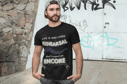 A man wears a black t-shirt with the text "Life Is One Long Rehearsal, Don't Expect an Encore" and musical notes.