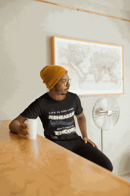 A man wears a black t-shirt with white text and musical notes.