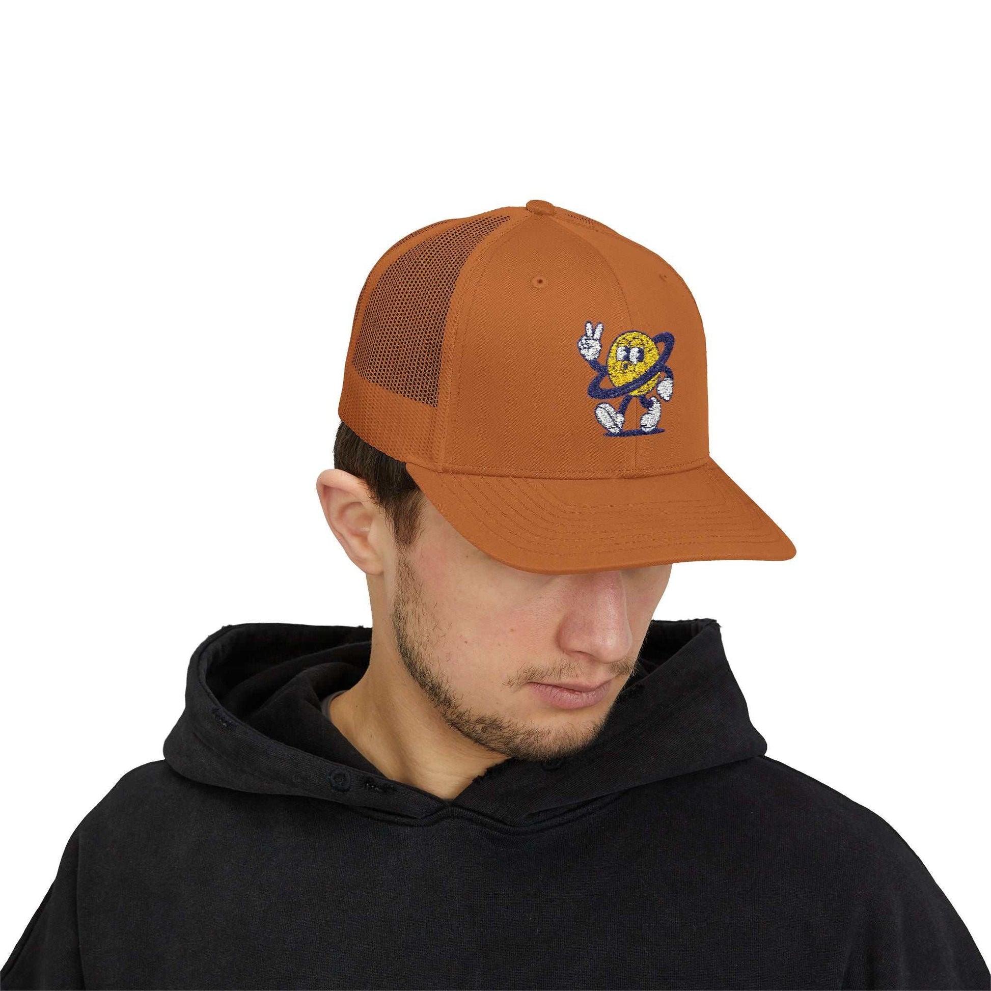 Brown Planet Smile Trucker Cap with retro cartoon space patch and breathable mesh back worn by male model
