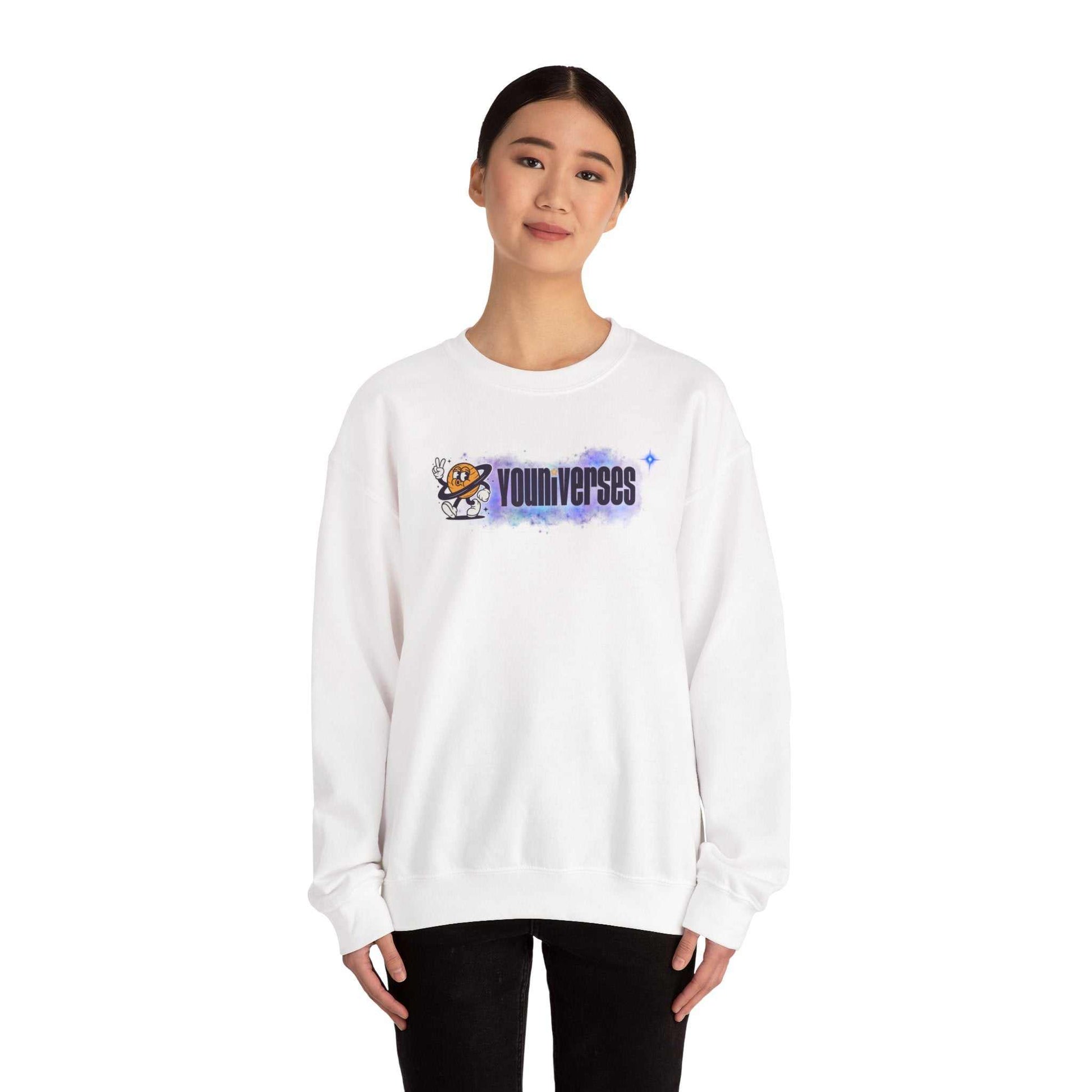 Woman wearing white Youniverses space logo crewneck sweatshirt with retro astronaut graphic and watercolor nebula design