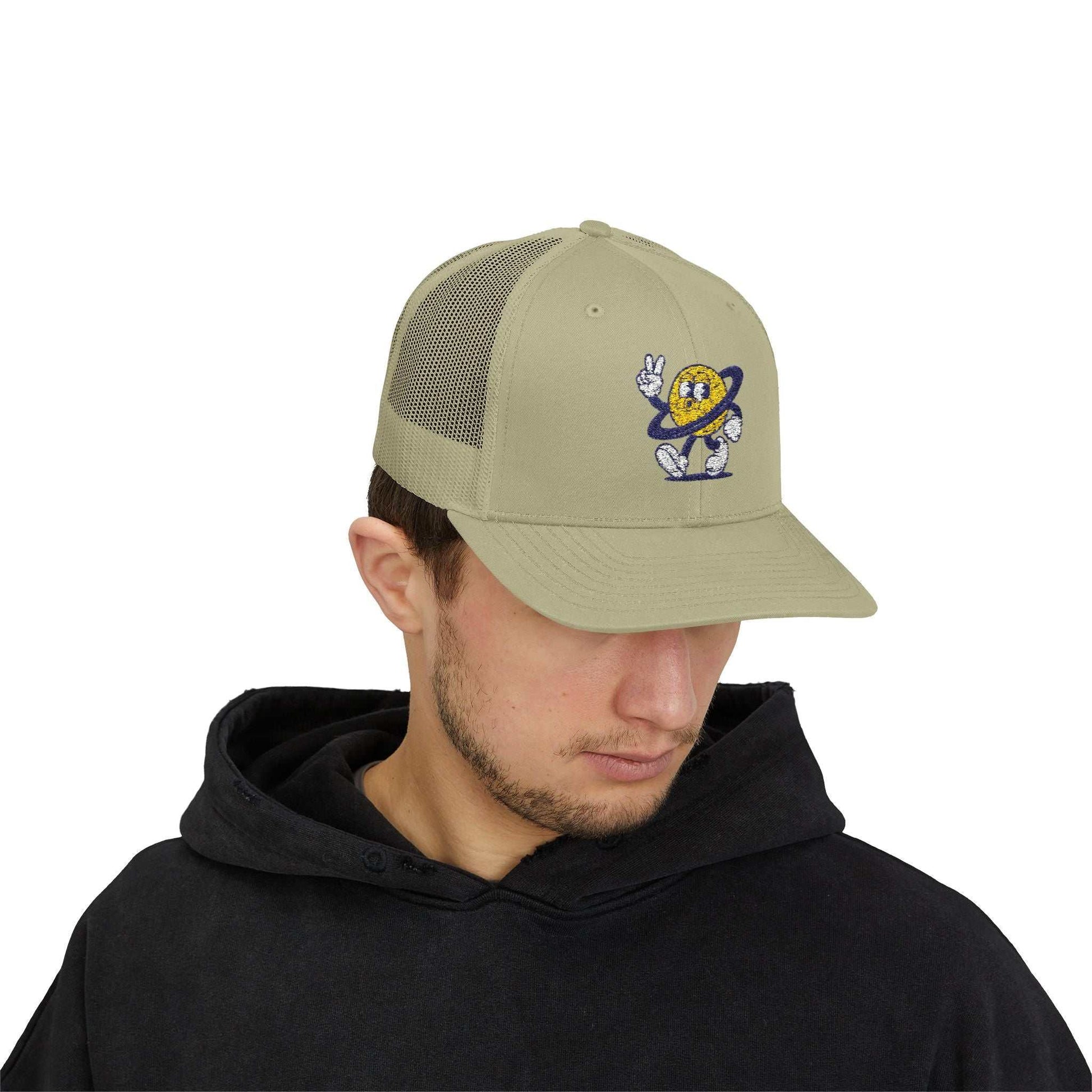 Beige Planet Smile Trucker Cap with retro cartoon space patch and breathable mesh back.