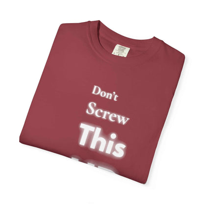 Folded maroon "Don't Screw This Up" motivational graphic t-shirt made of soft garment-dyed cotton
