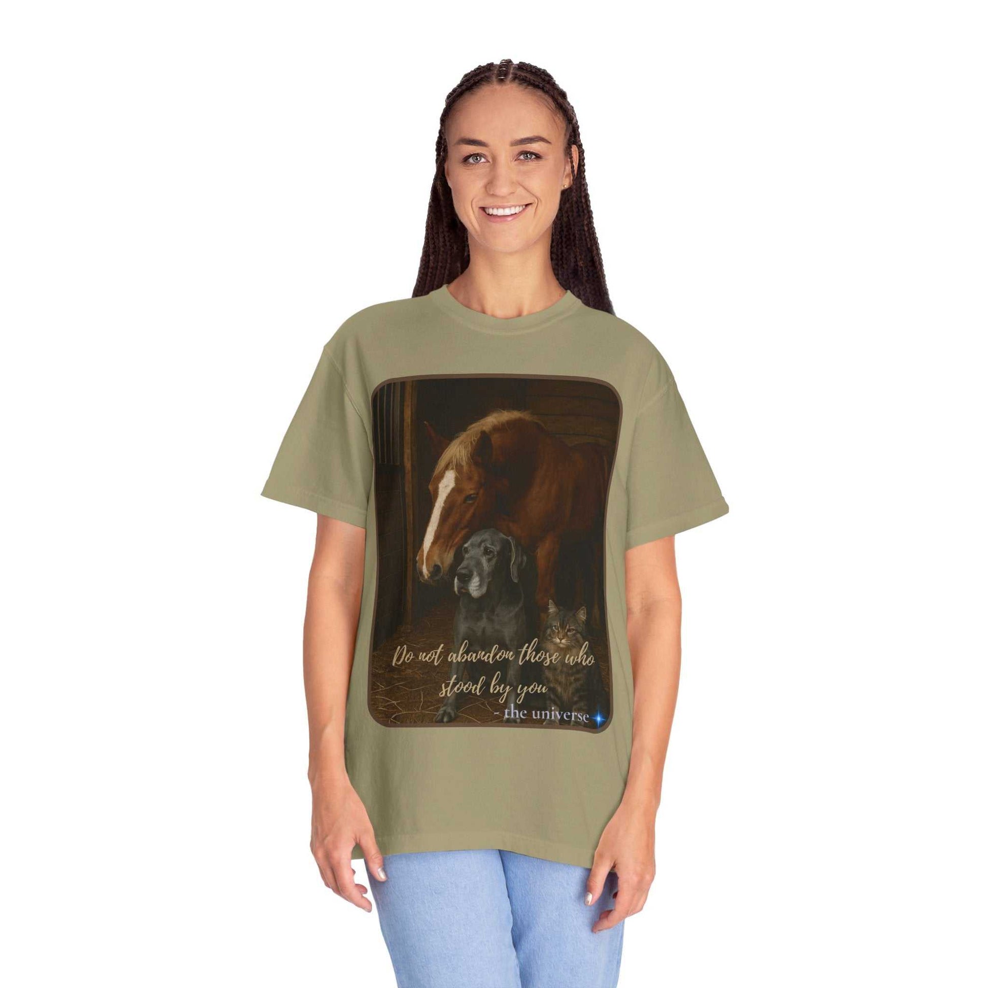Woman wearing olive green Comfort Colors 1717 Animal Rescue T-Shirt featuring horse and dog illustration with "Do Not Abandon Those Who Stood By You" text