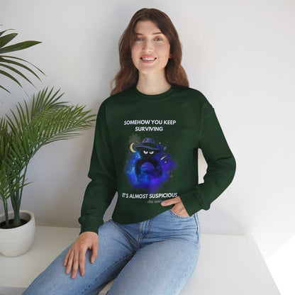A dark green sweatshirt with a cosmic graphic and text about surviving.