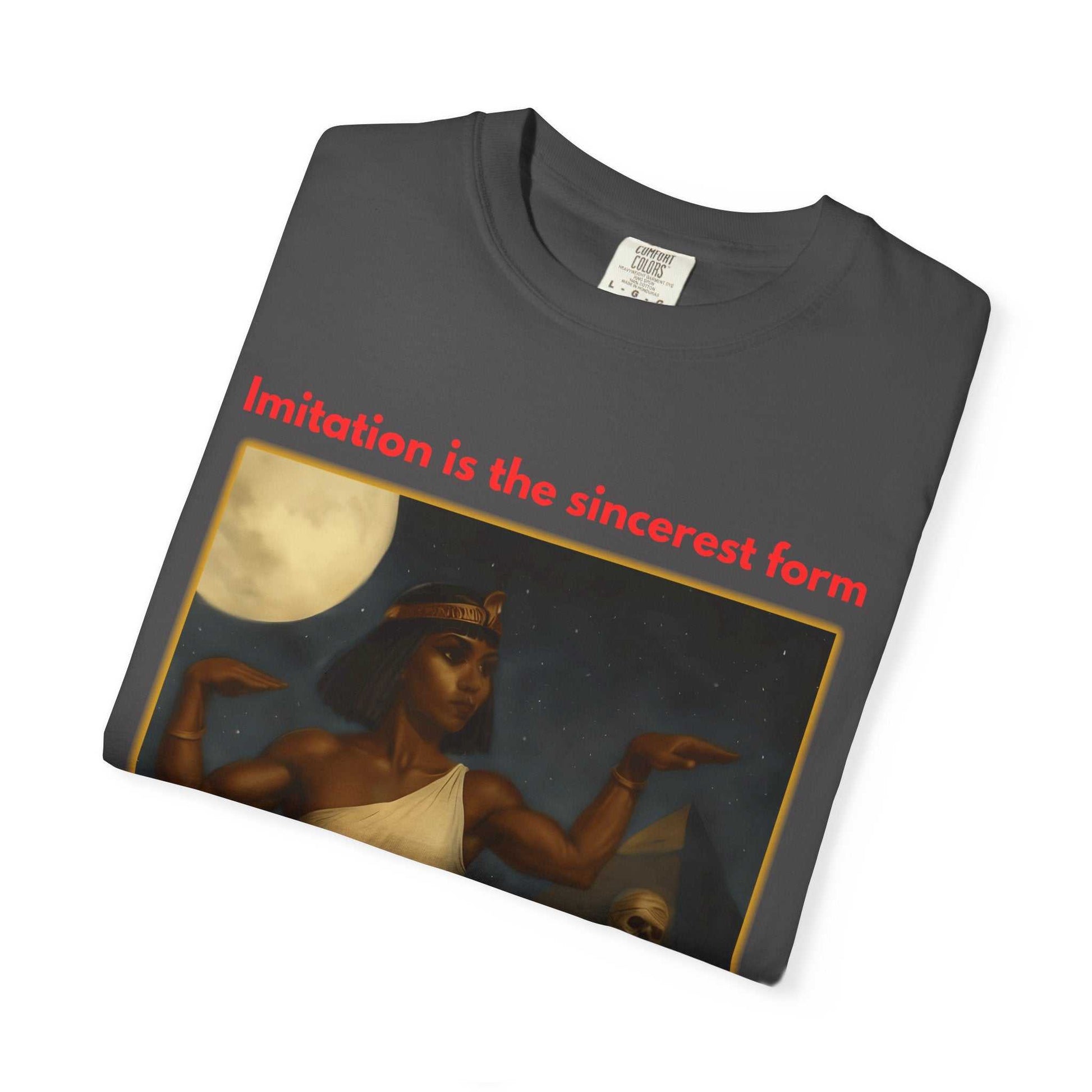 Folded black Egyptian Mummy T-Shirt with Cleopatra artwork and red text "Imitation is the sincerest form" on front