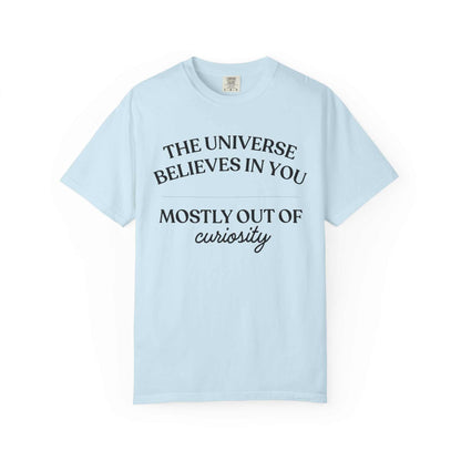 Light blue Comfort Colors graphic tee with 'The Universe Believes in You Mostly Out of Curiosity' text