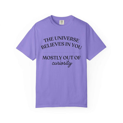 Purple graphic tee with 'The Universe Believes in You Mostly Out of Curiosity' text, Youniverses