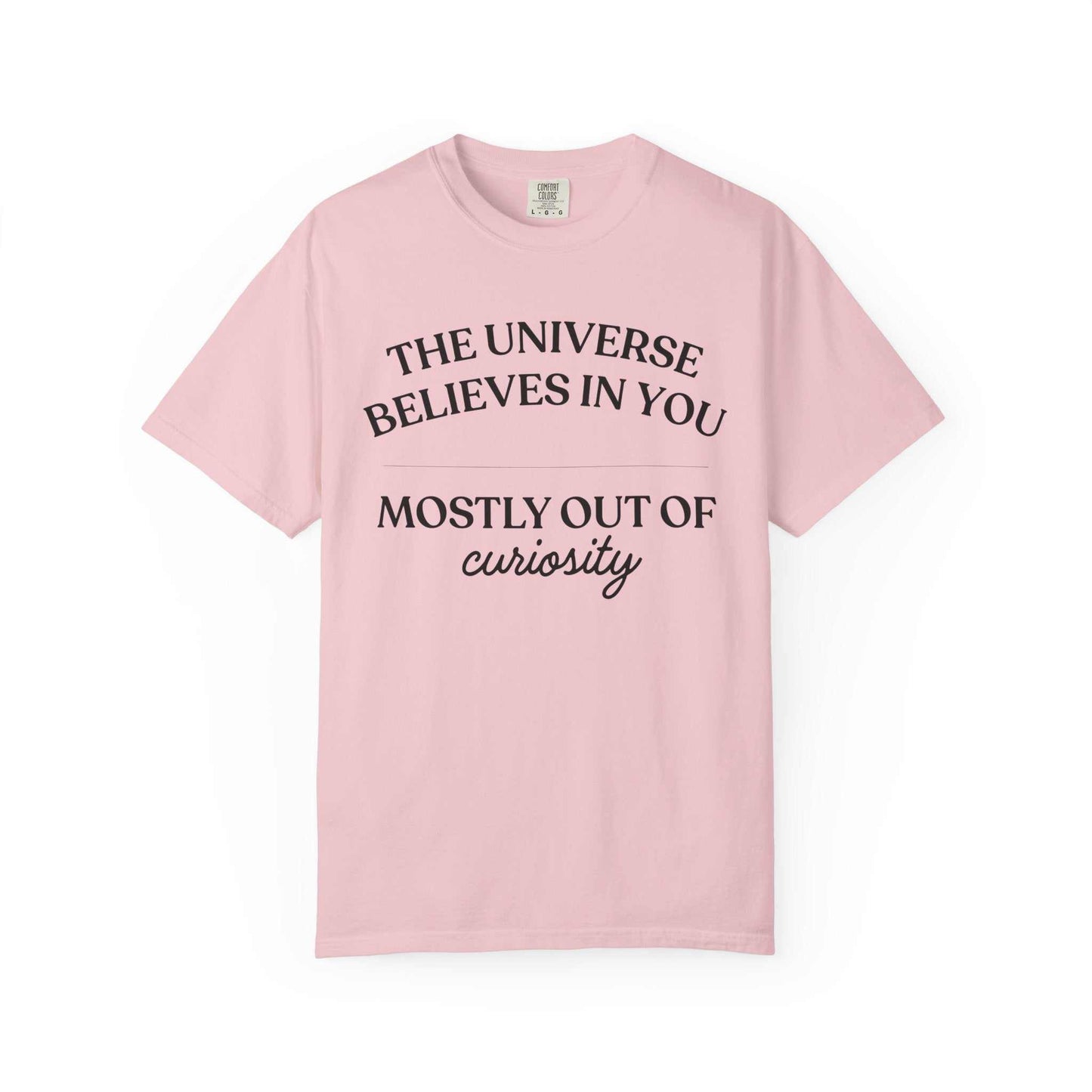 Light pink Comfort Colors graphic tee with black text: The Universe Believes in You, Mostly Out of Curiosity, Youniverses fashion.